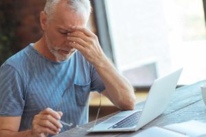elderly man annoyed computer scam