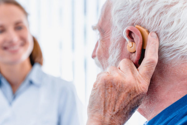Old man waring hearing aids