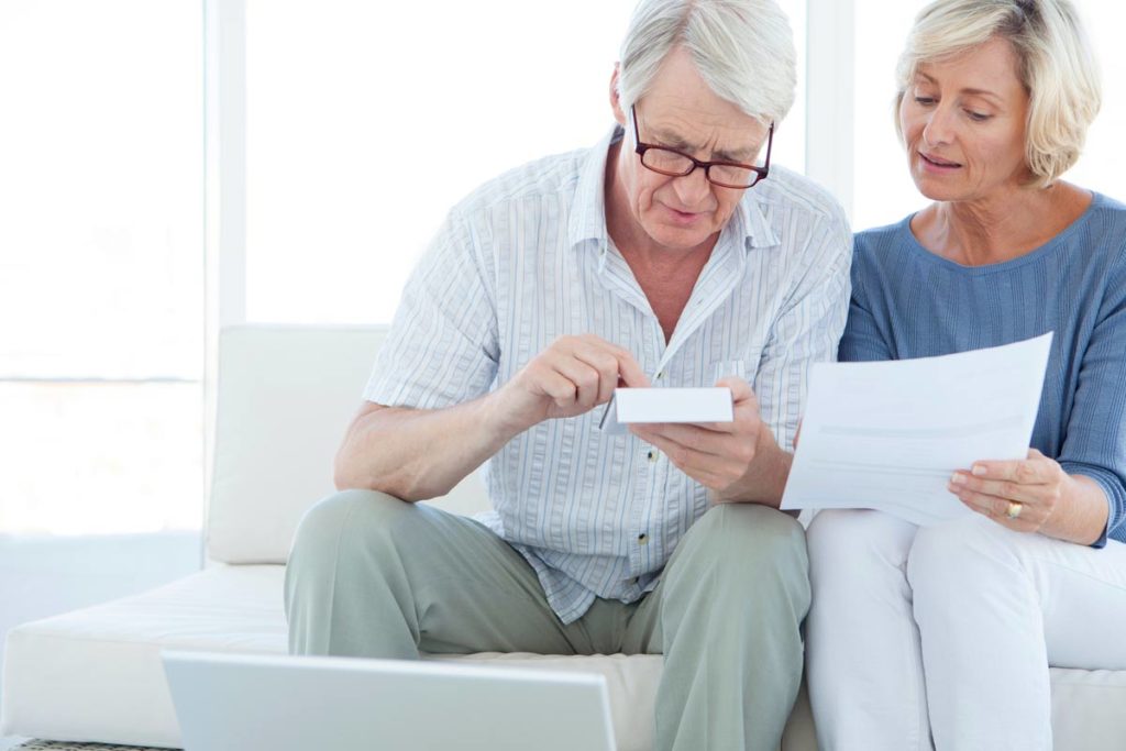 Elderly couple calculating and budgeting