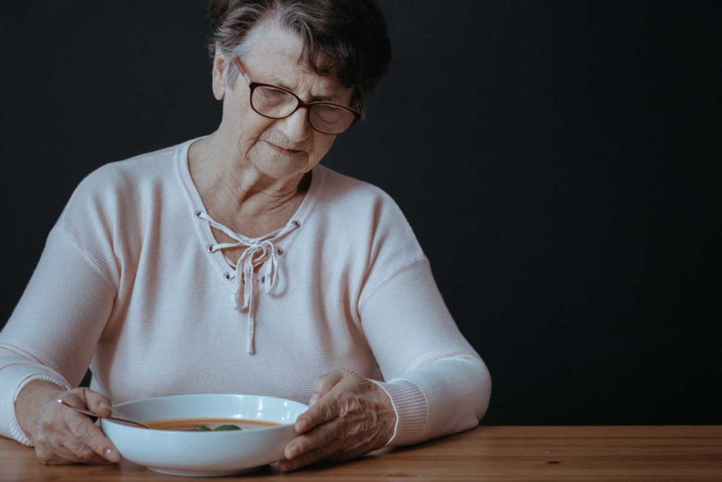 senior hunger, elderly woman looking at food