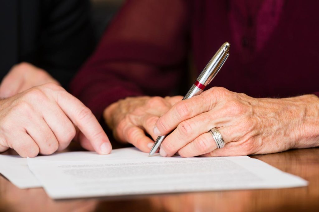 Elderly couple writing will