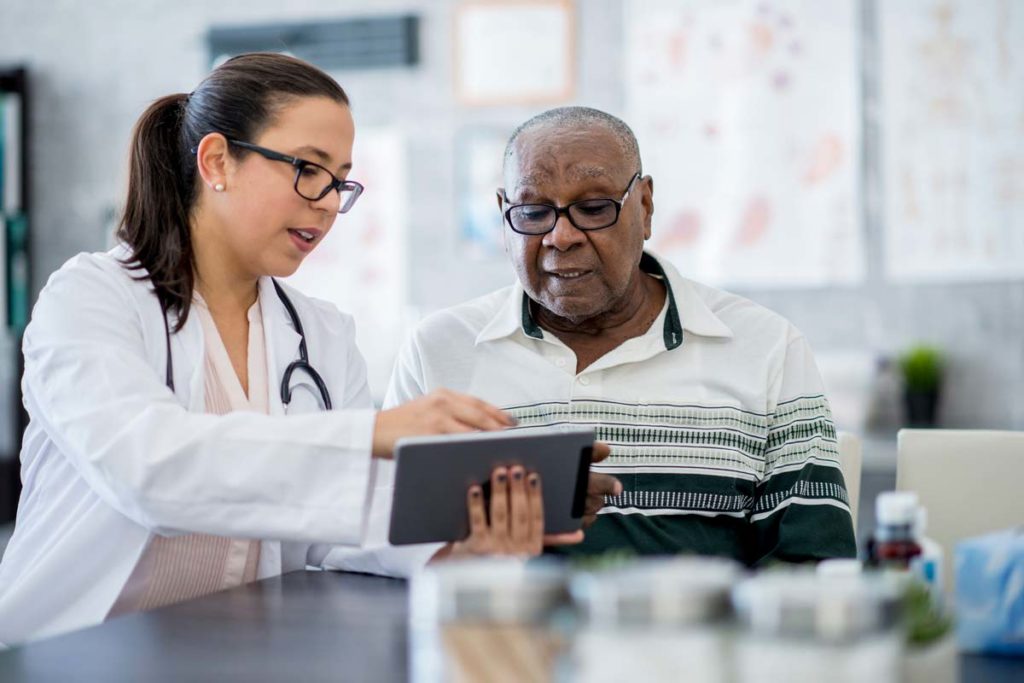 Elderly man talking with doctor about TeleHealth