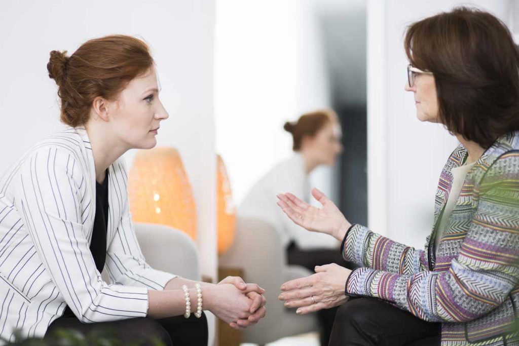 caregiver talking to a therapist