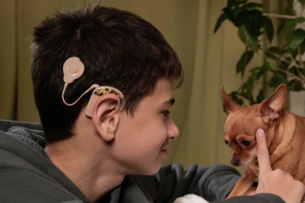 Deaf boy with cochlear implant playing