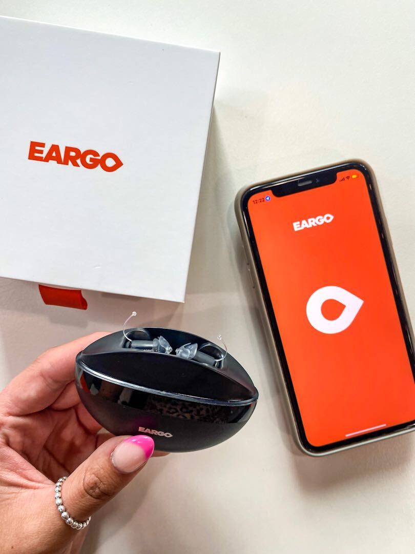 eargo hearing aid next to the eargo hearing aid app