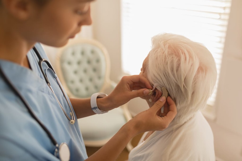 female physician caring for senior woman