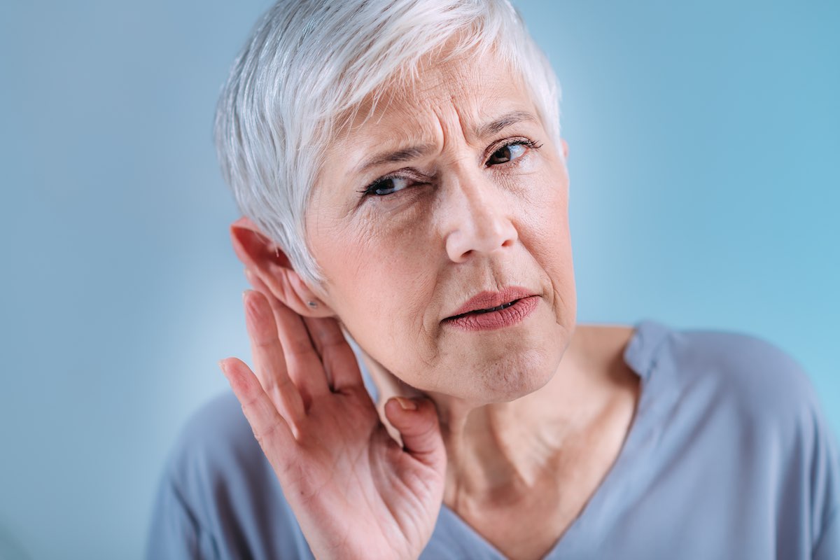 Hearing Loss. Senior Woman with Symptoms of Hearing Loss.