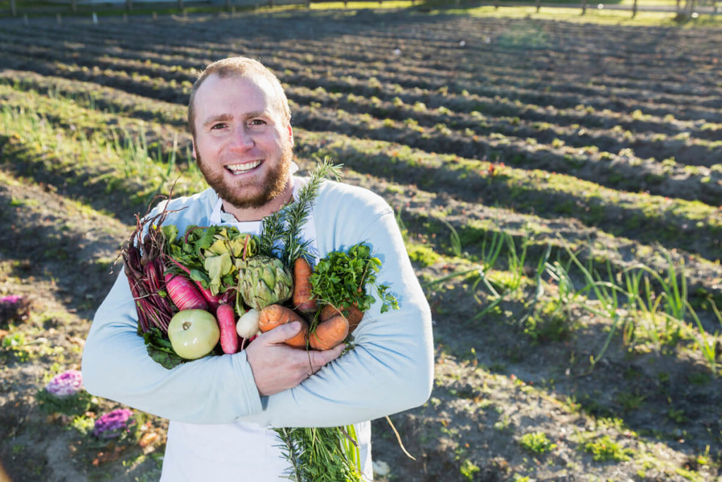 man holding vegetables