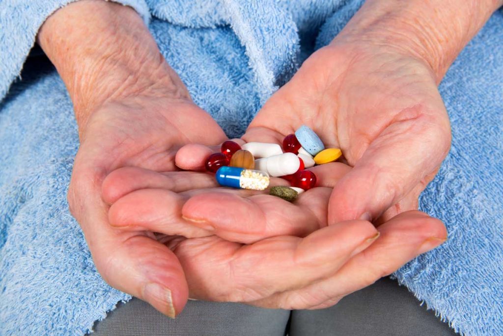 medication pills open hands