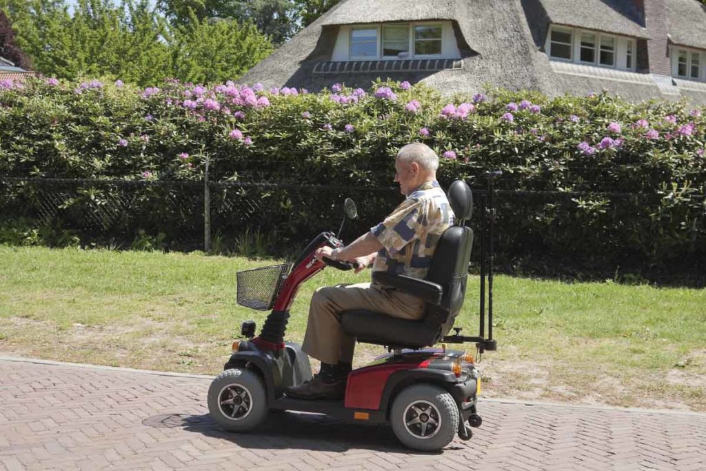 senior man riding a mobility scooter