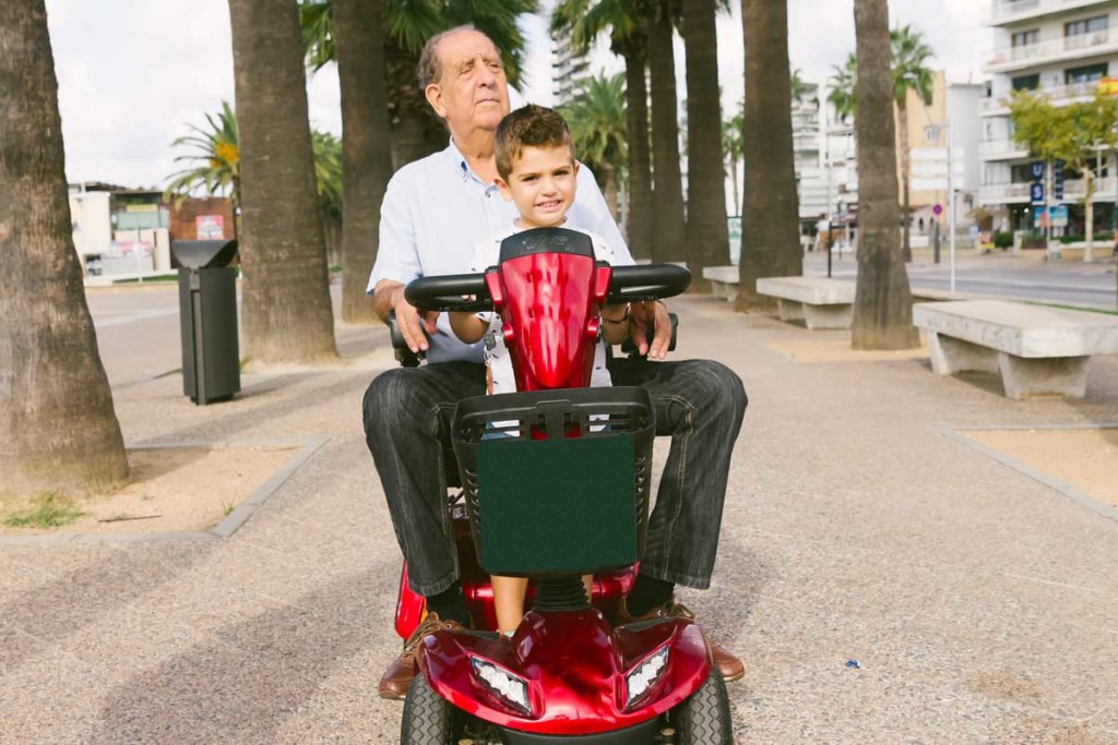 Man with his child in mobility scooter