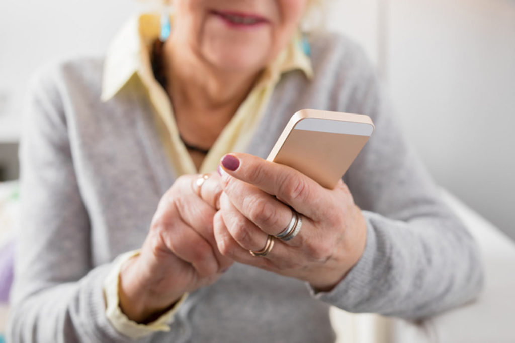 older women checking phone