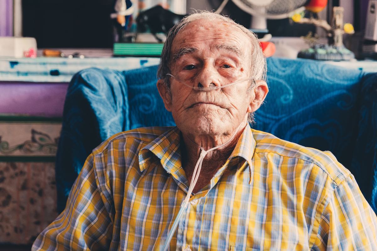 An elderly using portable oxygen concentrator