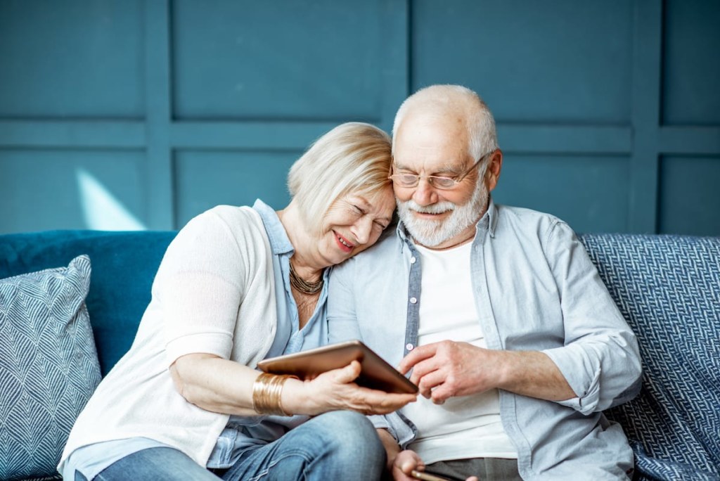 senior couple with tablet at home