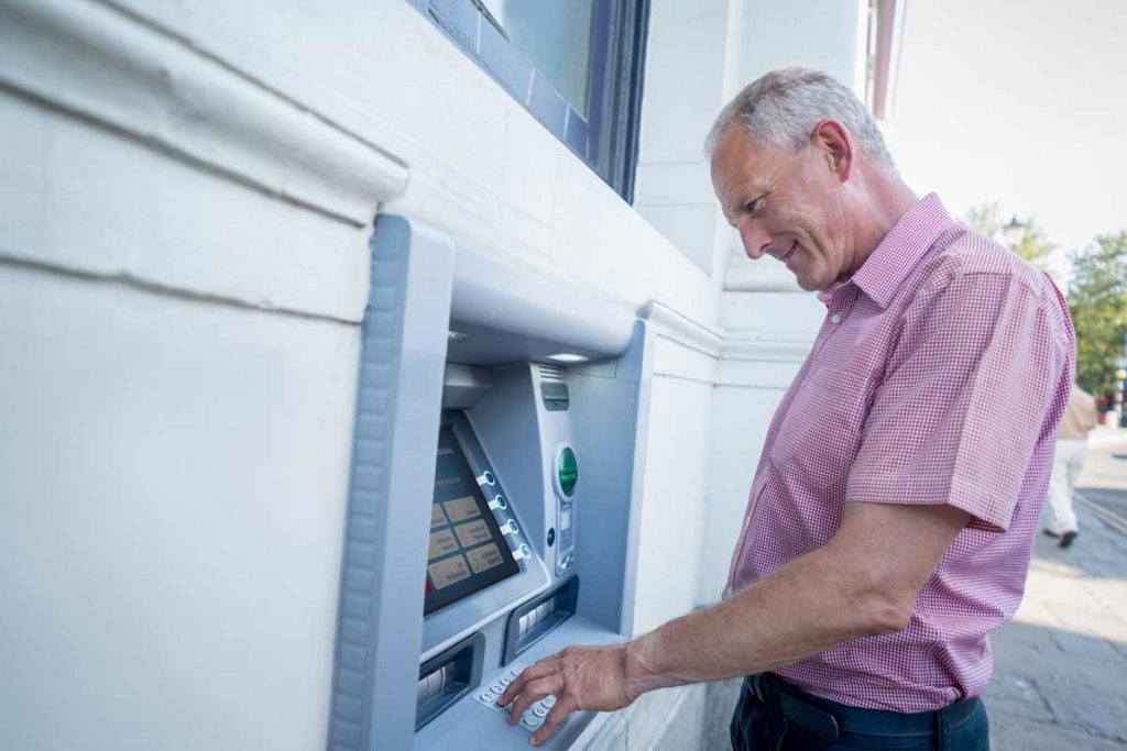 senior man at an ATM