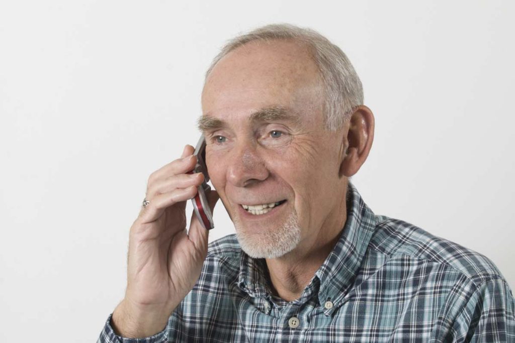 senior man on flip phone