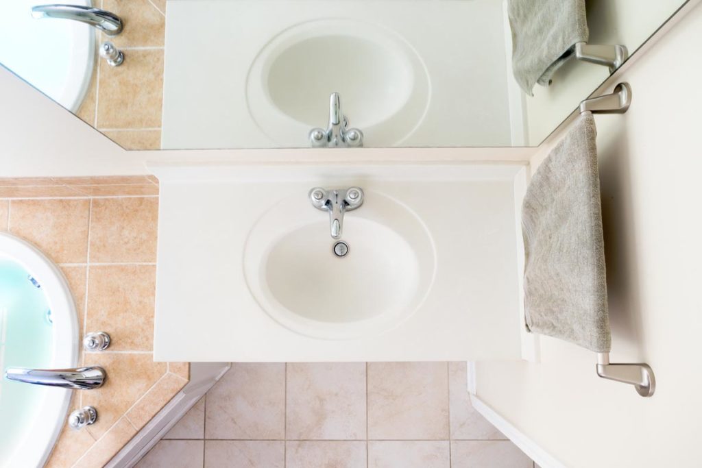 Overhead View of Classical Acrylic Top Sink along with a full bathtub and faucets