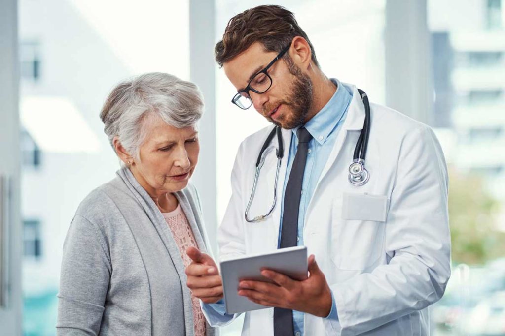 older woman visiting with doctor