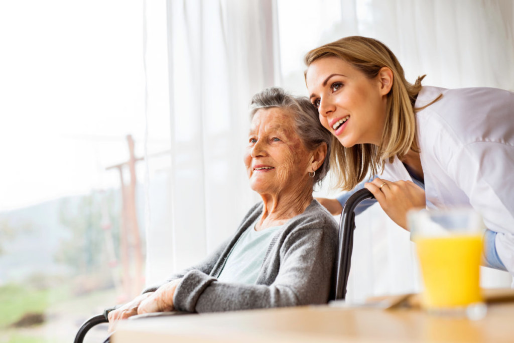 Senior Woman with nurse looking at something happily
